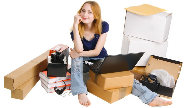 Girl online shopping and sitting with delivered packages
